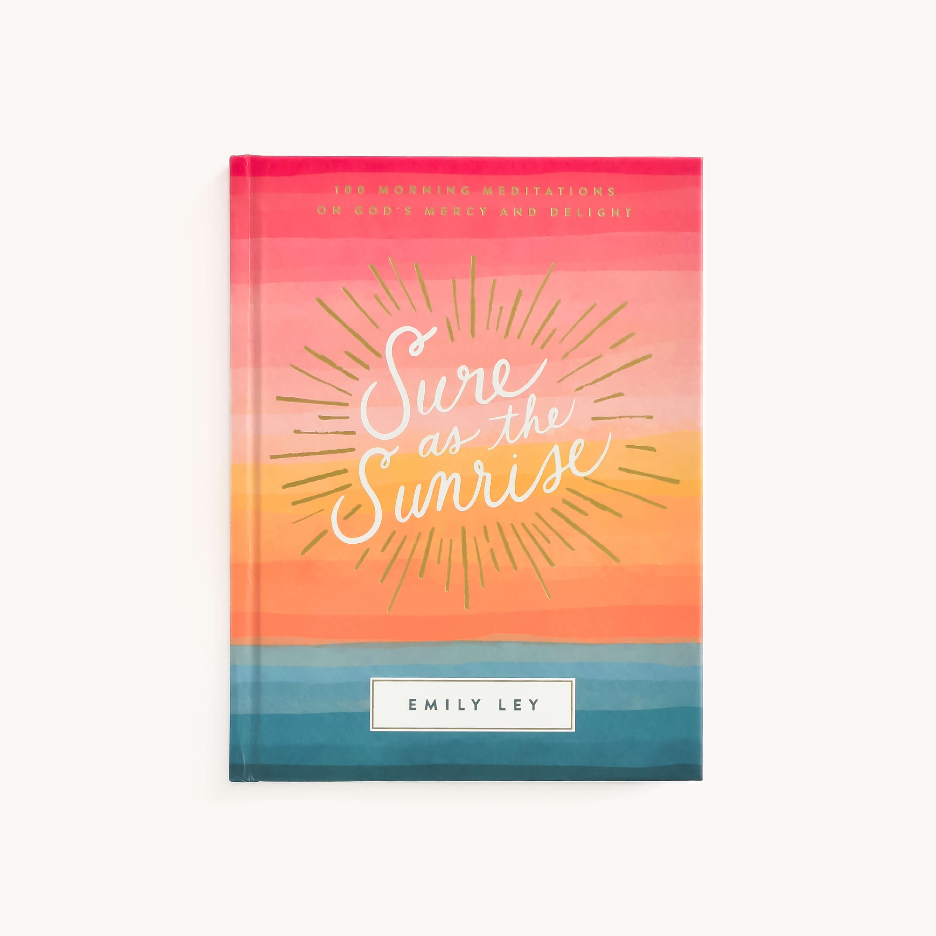 The cover of Sure as the Sunrise by Emily Ley, published under Simplified, showcases vibrant horizontal stripes in pink, orange, coral, and teal. A sun with rays surrounds the title and above it reads: 180 Morning Meditations on Gods Mercy and Delight.