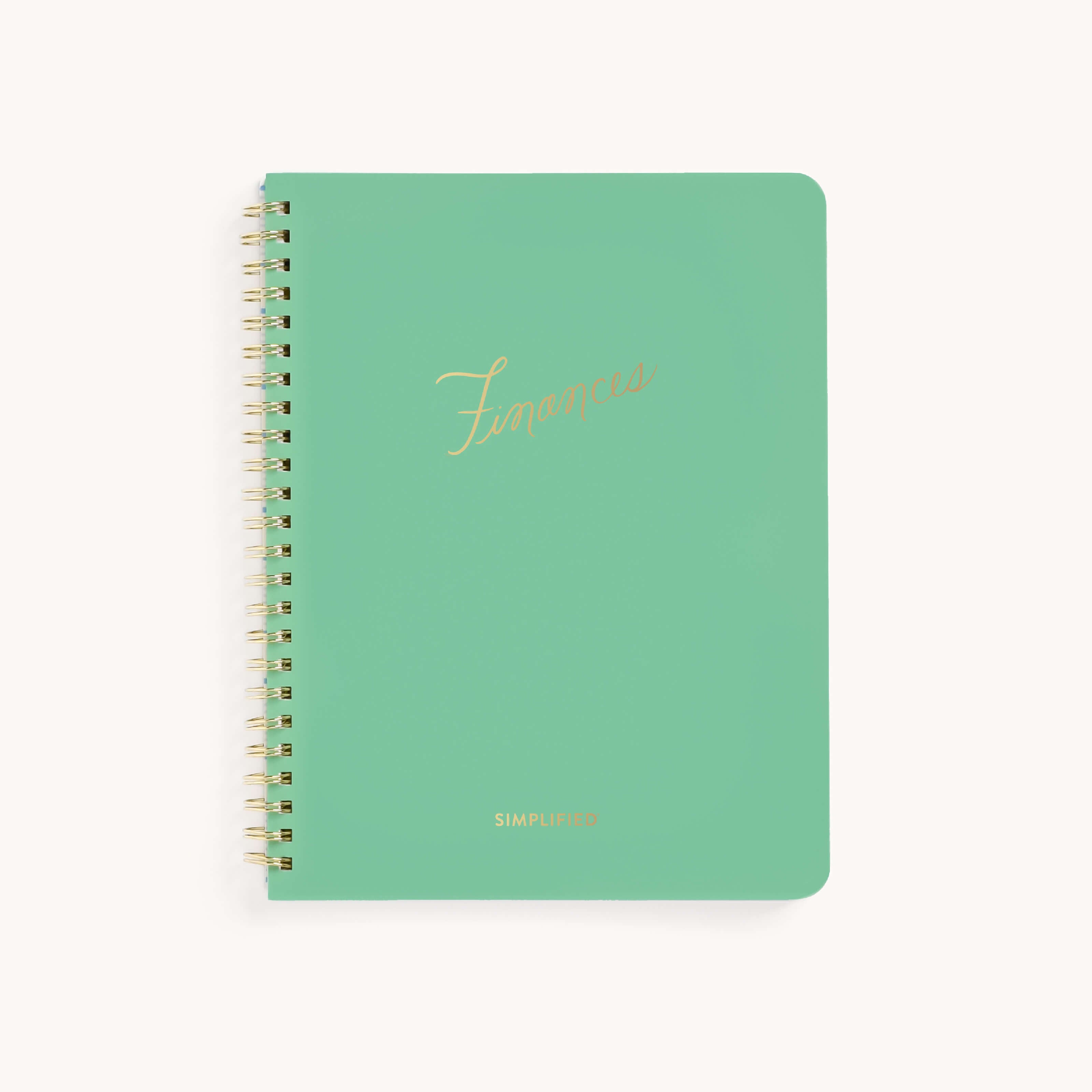 A green spiral-bound Workbook - Finances by Simplified features Finances in gold cursive on the cover. Its perfect for money management, with Simplified printed in small white letters at the bottom to keep your financial goals on track.