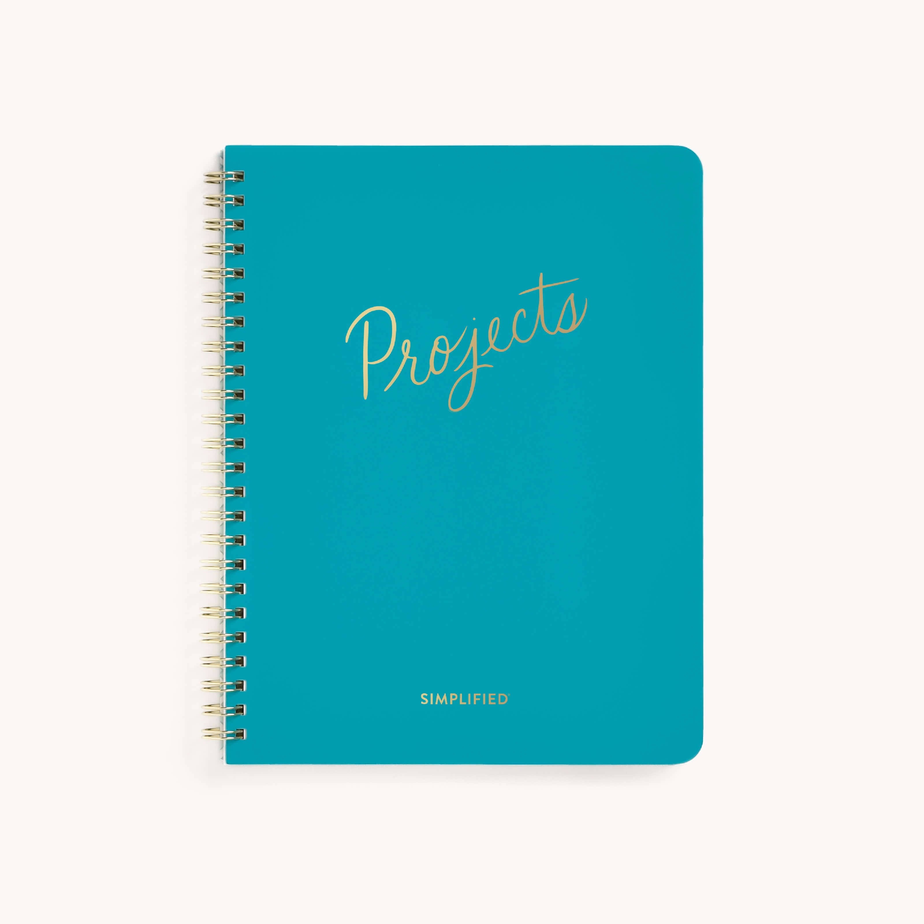 A blue spiral-bound Workbook - Project Management from Simplified features Projects in gold cursive on the cover, with Simplified beneath it in small gold letters, ideal for monthly spreads, set against a plain white background.