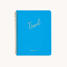 The Workbook - Travel Planning by Simplified is a vibrant blue spiral-bound notebook with Travel in cursive and SIMPLIFIED in bold on the bottom. It features a white background and is designed to streamline your travel plans elegantly.