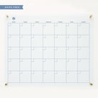 The Simplified Monthly Acrylic Wall Calendar is a white, grid-style dry-erase board perfect for organizing dates. It features days labeled from Sunday at the top and is secured by gold fixtures. A SHIPS FREE! banner is displayed at the top left corner, offering a stylish management solution for your monthly schedule.