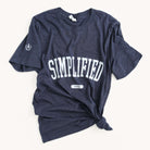 The unisex Simplified Collegiate Tee features SIMPLIFIED in bold white across the front, a white oval with 2009, and a stylish side knot. Made from soft materials, this dark blue t-shirt is part of our classic fits collection with a small logo on the right sleeve.