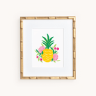 The Art Print - Pineapple Party by Simplified features a stylish framed pineapple with green leaves, surrounded by pink and red flowers. The bamboo frame enhances its elegance, making it the perfect wall decor for off-white backgrounds, ideal for fans of unique art prints.