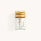 Simplified by Emily Ley | Mechanical Pencil Erasers within a small jar with gold twist lid.