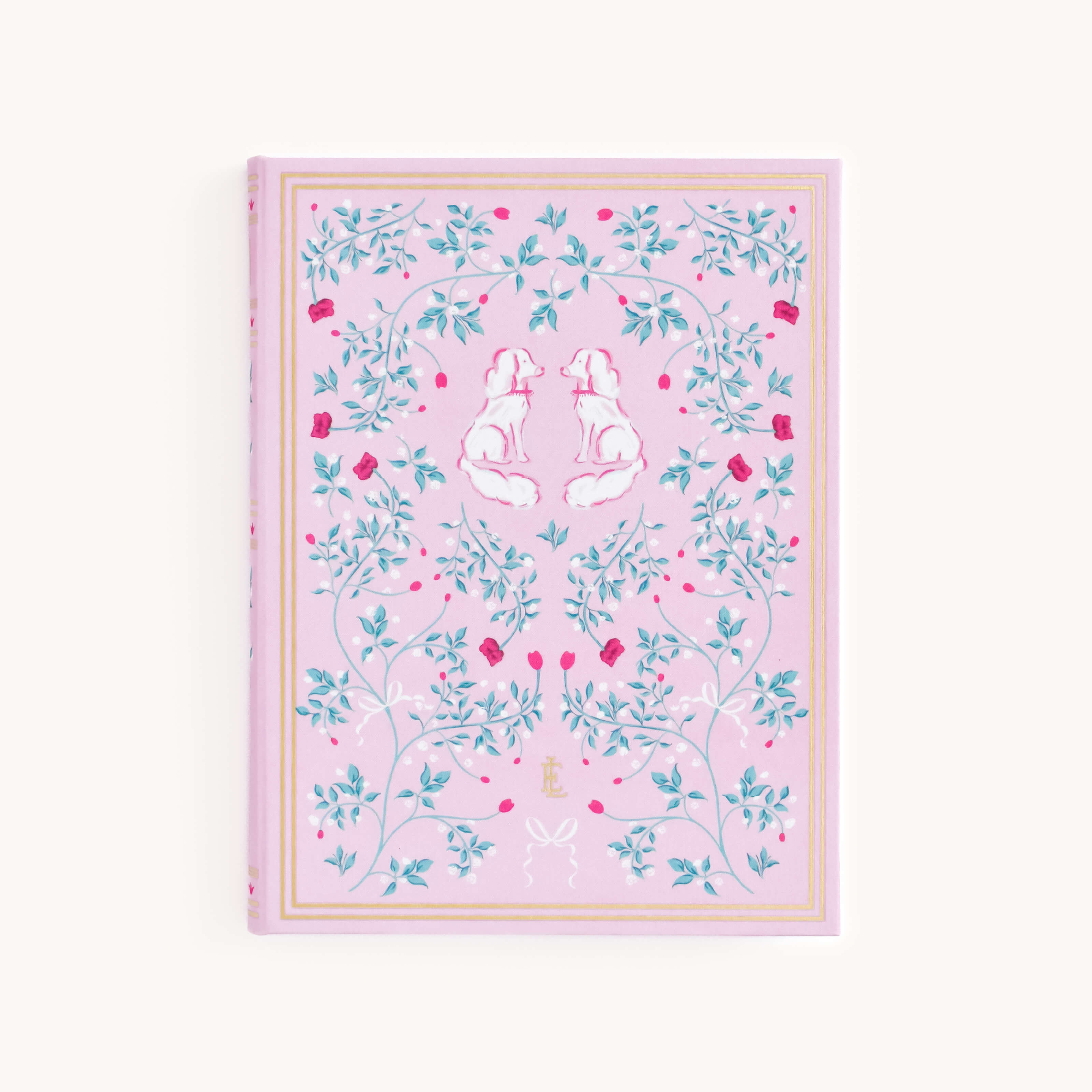 The Linen Journal - Blush by Simplified features a pink cover with two white dogs reflected amid green leaves and red flowers. It includes a golden border and an E at the bottom, perfect for sparking creativity.