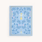 The Linen Journal - Carolina by Simplified features a light blue cover adorned with detailed floral and key motifs in blue and gold. A ribbon-tied key design highlights the center, surrounded by an elegant gold border, creating a masterpiece for reflection.