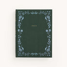 The Simplified Linen Journal - Grace features a dark green hardcover with GRACE embossed in gold at the center. It boasts intricate, hand-painted light blue floral designs along the edges, creating a delicate border of leaves and flowers.