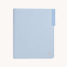 The Leatherette File Folder - French Blue by Simplified is a light blue office organizer with a small gold emblem in the bottom right corner. It features a right-side tab for secure and easy document access, all on a white background.