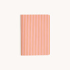 The Mini Notebook - Cabana Pinstripe by Simplified features a thick paper cover with vertical orange and white stripes on a light gray background.