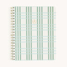 The Notebook - Pistachio Plaid by Simplified features a spiral-bound design with gold wire-o binding and a light green and cream plaid cover. It has a small, gold emblem on the center of its soft-touch cover on a plain white backdrop.