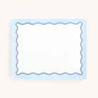 The Simplified Notepad - Scallop Lined features a blue scalloped border and gold foil accents. It has horizontal blue lines with Take Note at the top, measures 8 x 10, and rests on a light beige background.