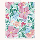 The Blush Magnolia Jiggy Puzzle by Simplified showcases a watercolor light blue background adorned with large blush magnolias, peach flowers, intertwined with green leaves and small blue blooms.