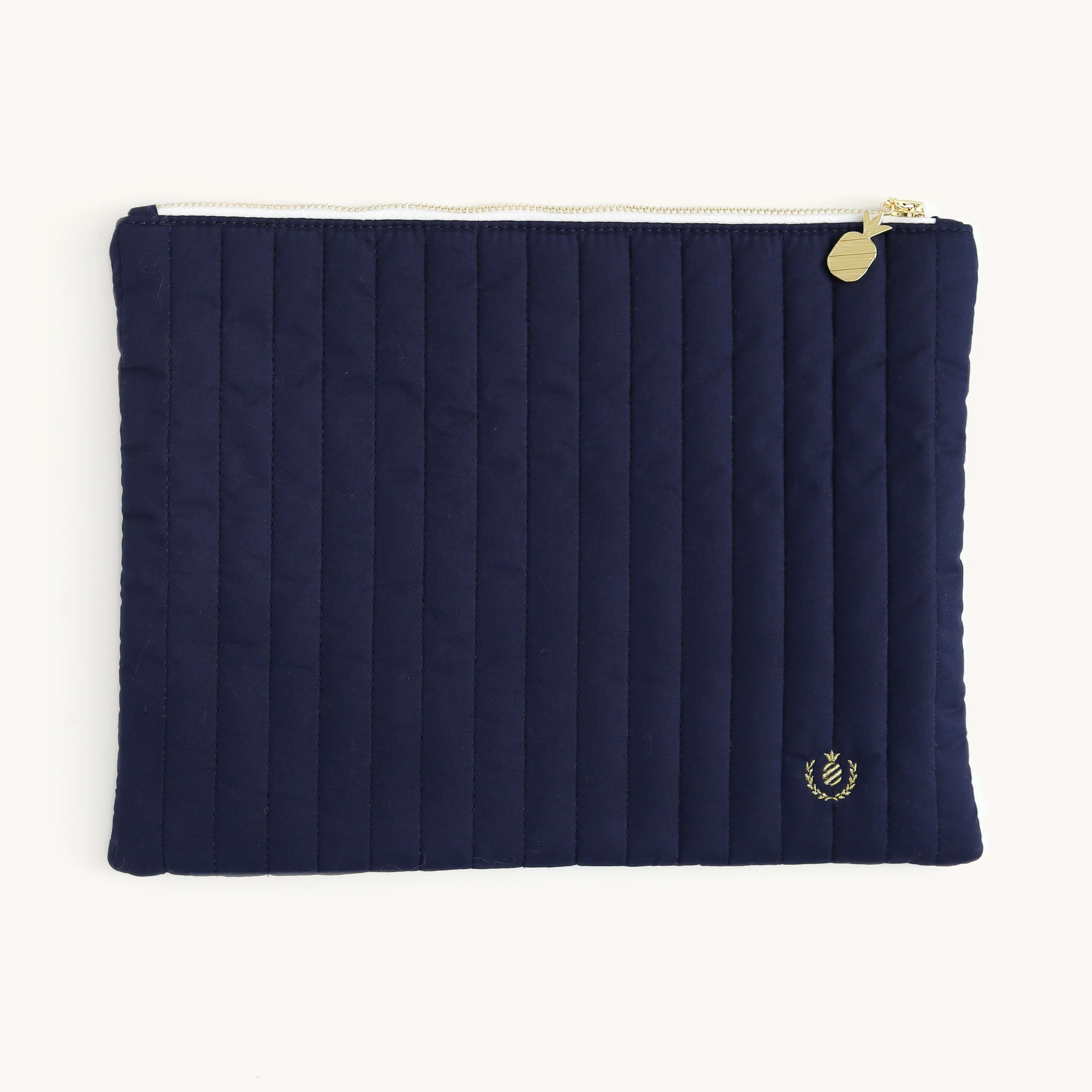 Simplified Navy Quilted Pouch featuring a quilted cotton exterior, shiny gold zipper teeth, pineapple-shaped gold zipper pull, and a gold pineapple embroidered detail.