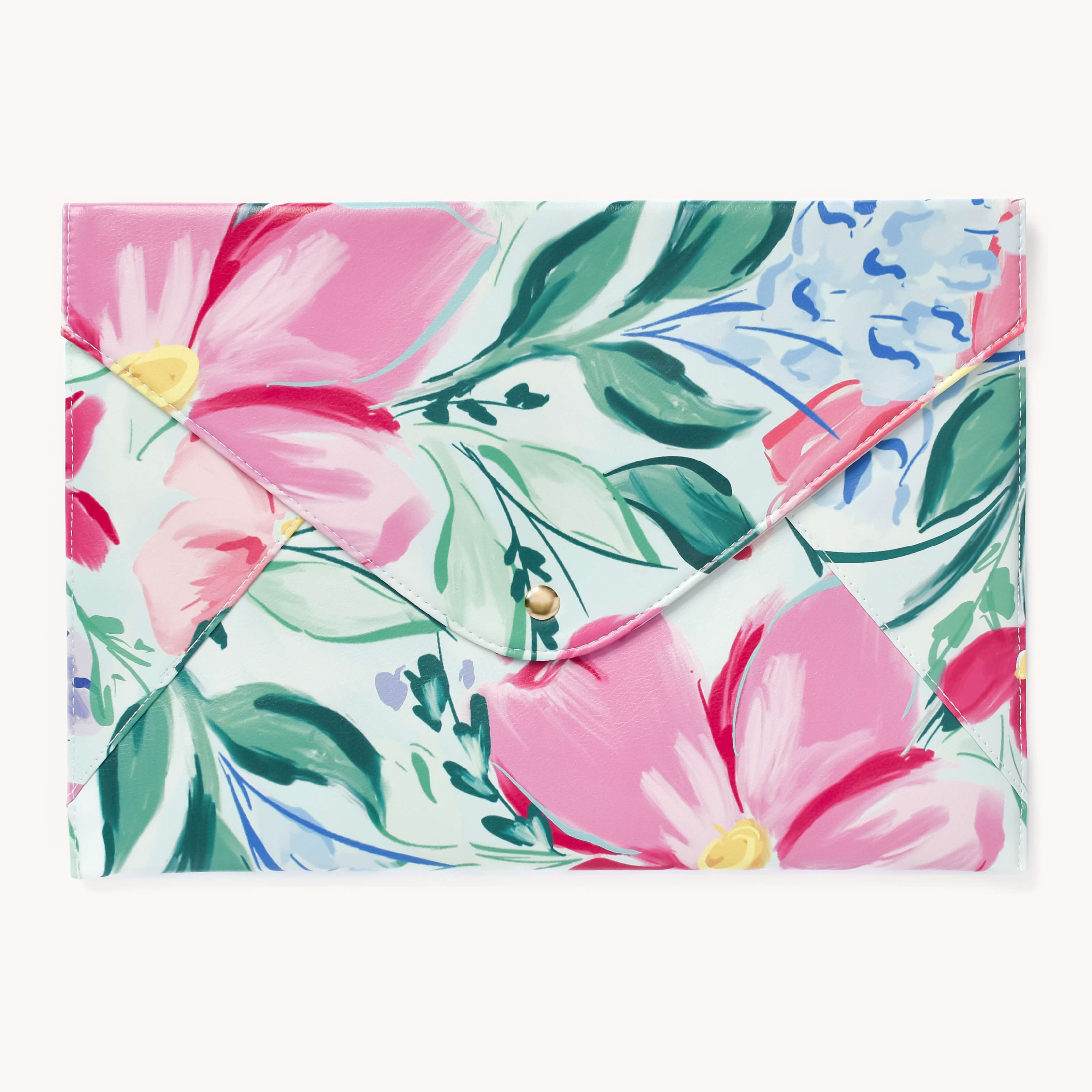 The Simplified Leatherette Tech Case - Blush Magnolia is an envelope-style clutch with pink floral patterns, green leaves, and blue accents on a white background, crafted from leatherette. It features a magnetic closure for secure carry.