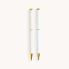 Simplified by Emily Ley | Twist Pen Set featuring two metal pens in Ivory Antelope and Coastal Stripe designs. Each pen has a gold twist mechanism. 