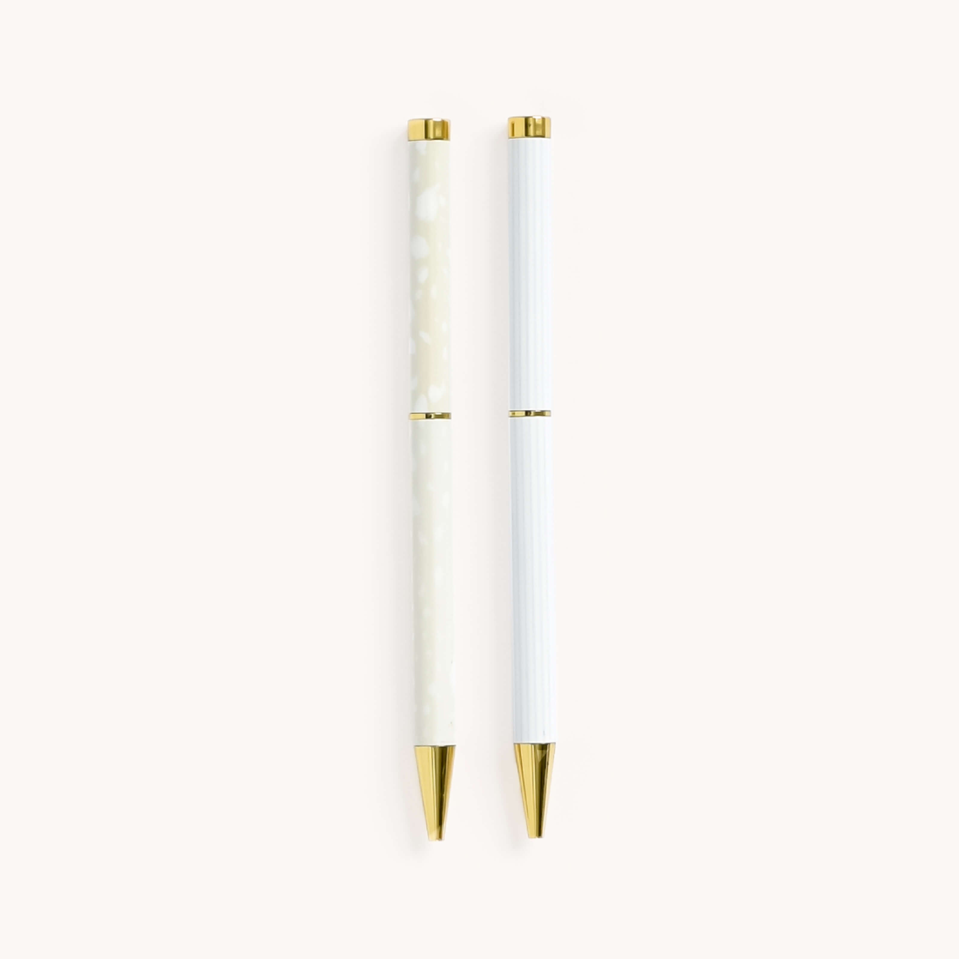 Simplified by Emily Ley | Twist Pen Set featuring two metal pens in Ivory Antelope and Coastal Stripe designs. Each pen has a gold twist mechanism. 