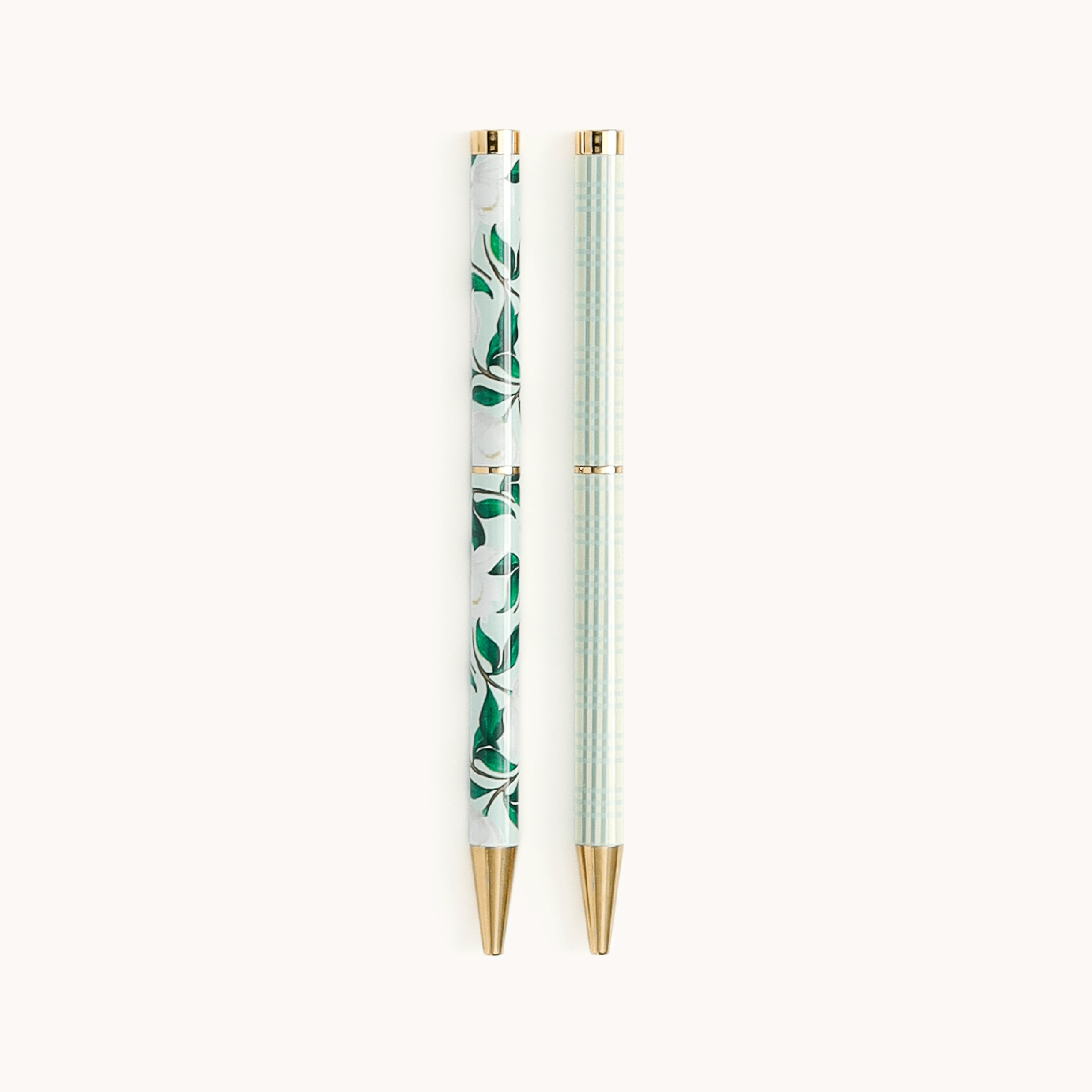 Simplified by Emily Ley | Twist Pen Set featuring two metal pens in Savannah Blooms and Pistachio Plaid designs. Each pen has a gold twist mechanism. 