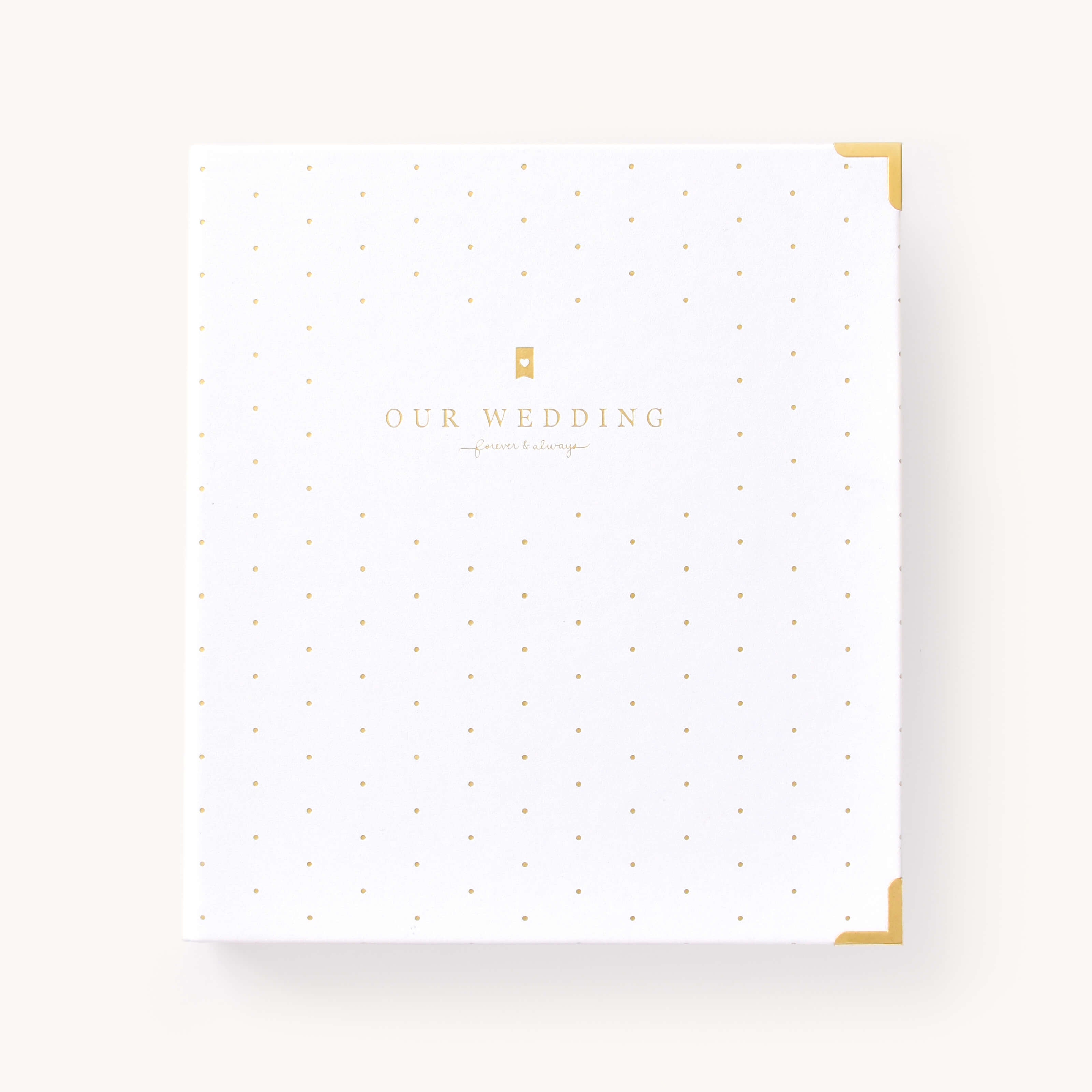 Simplified Wedding Planner by Simplified by Emily Ley featuring a white leatherette cover with gold foil dot pattern and protective gold corners.