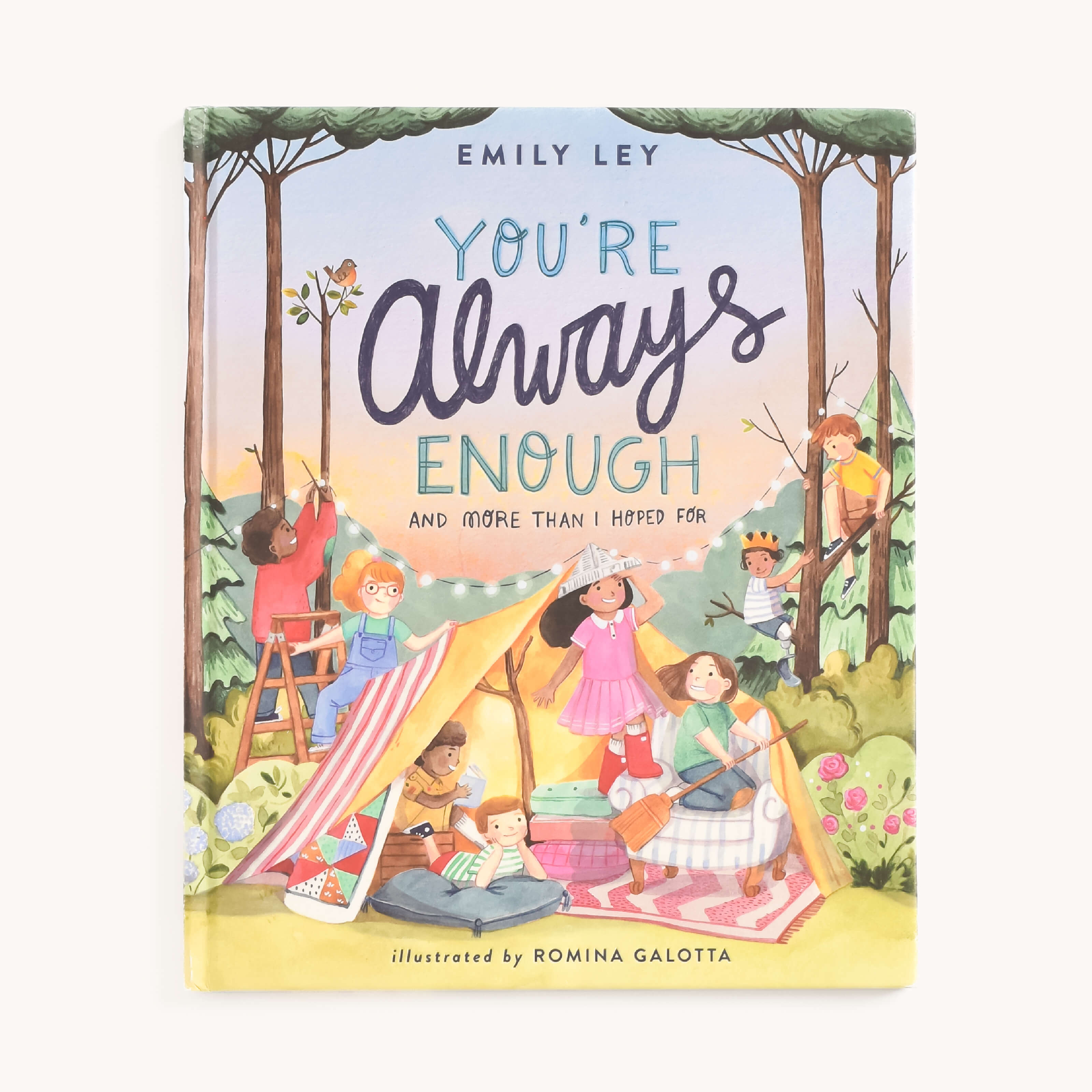 Cover of Youre Always Enough by Emily Ley under the Simplified brand, illustrated by Romina Galotta. The book highlights individuality and self-esteem with children playing near a colorful tent in a forest, set against trees and a pastel sky.