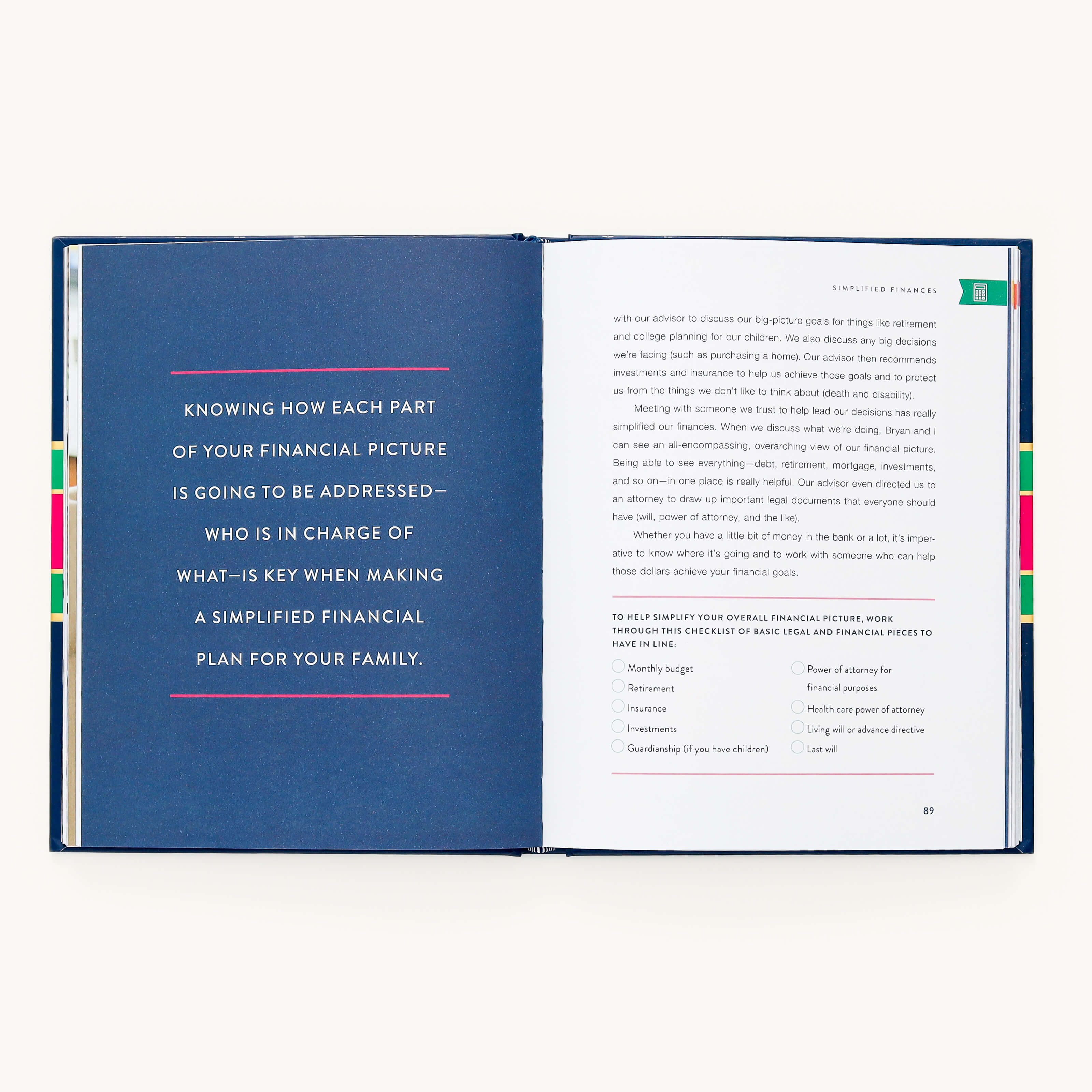 The open book, A Simplified Life by Emily Ley, features a quote about family financial planning on the left page and practical tips along with checklist items for family finances on the right. The ensemble is accentuated by vibrant tabs.