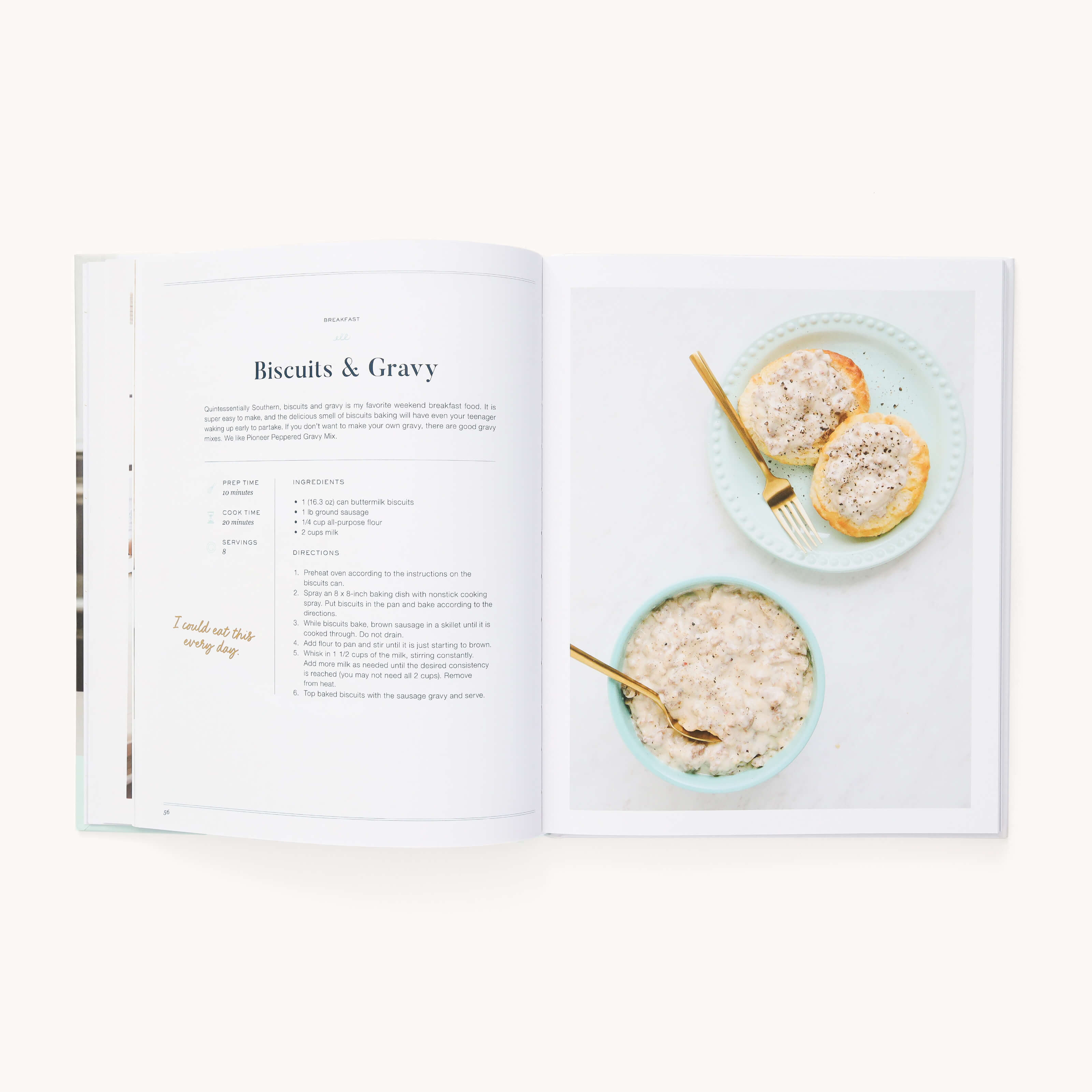 Open *The Simplified Cookbook* by Emily Ley to find a Biscuits & Gravy recipe. The left page has text and instructions, while the right features a photo of biscuits with gravy on a plate next to a bowl of gravy. Ideal for those who enjoy easy cooking from Simplified.