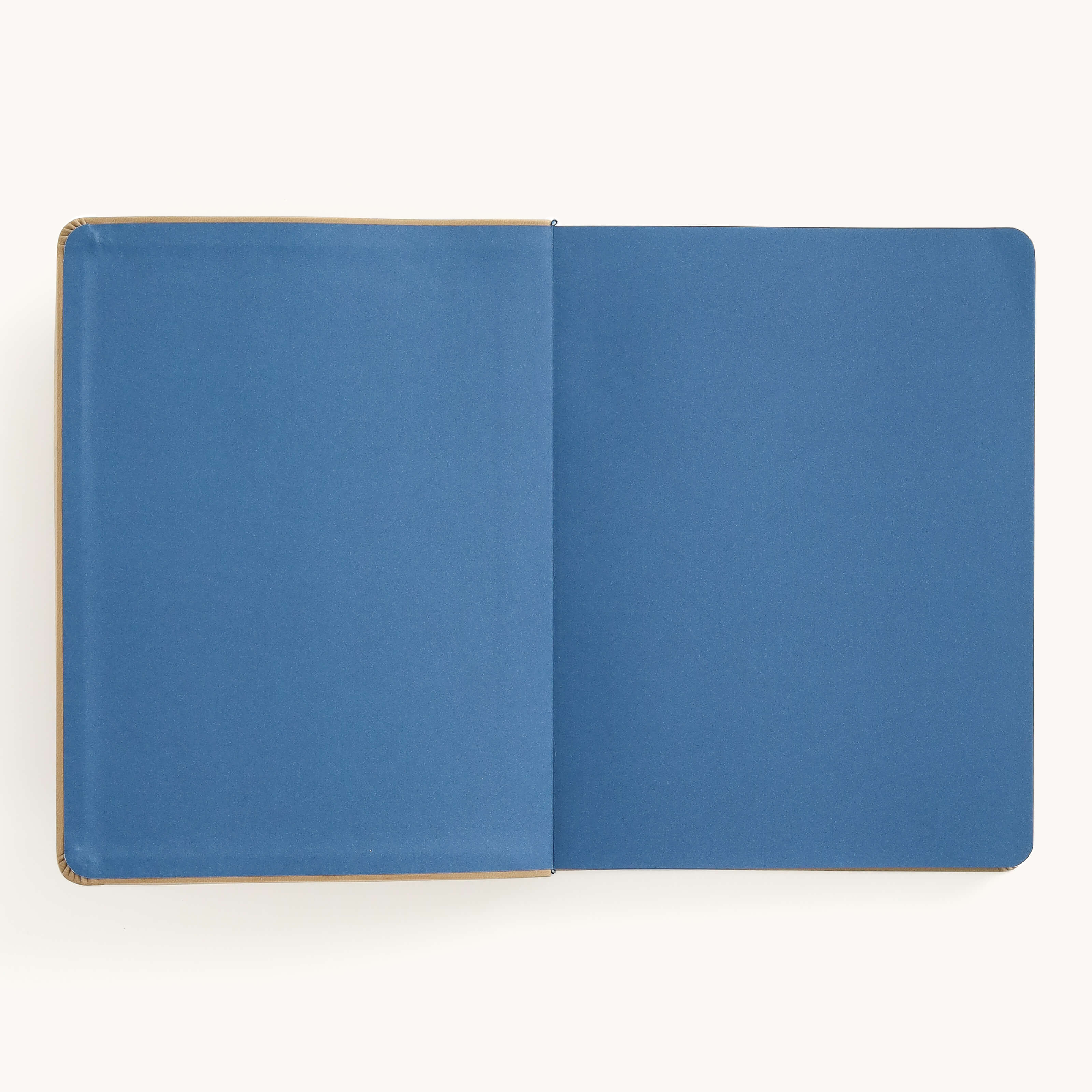 The Simplified Leatherette Journal - Fawn, featuring blank blue pages and gold foil details, is set against a plain white background.