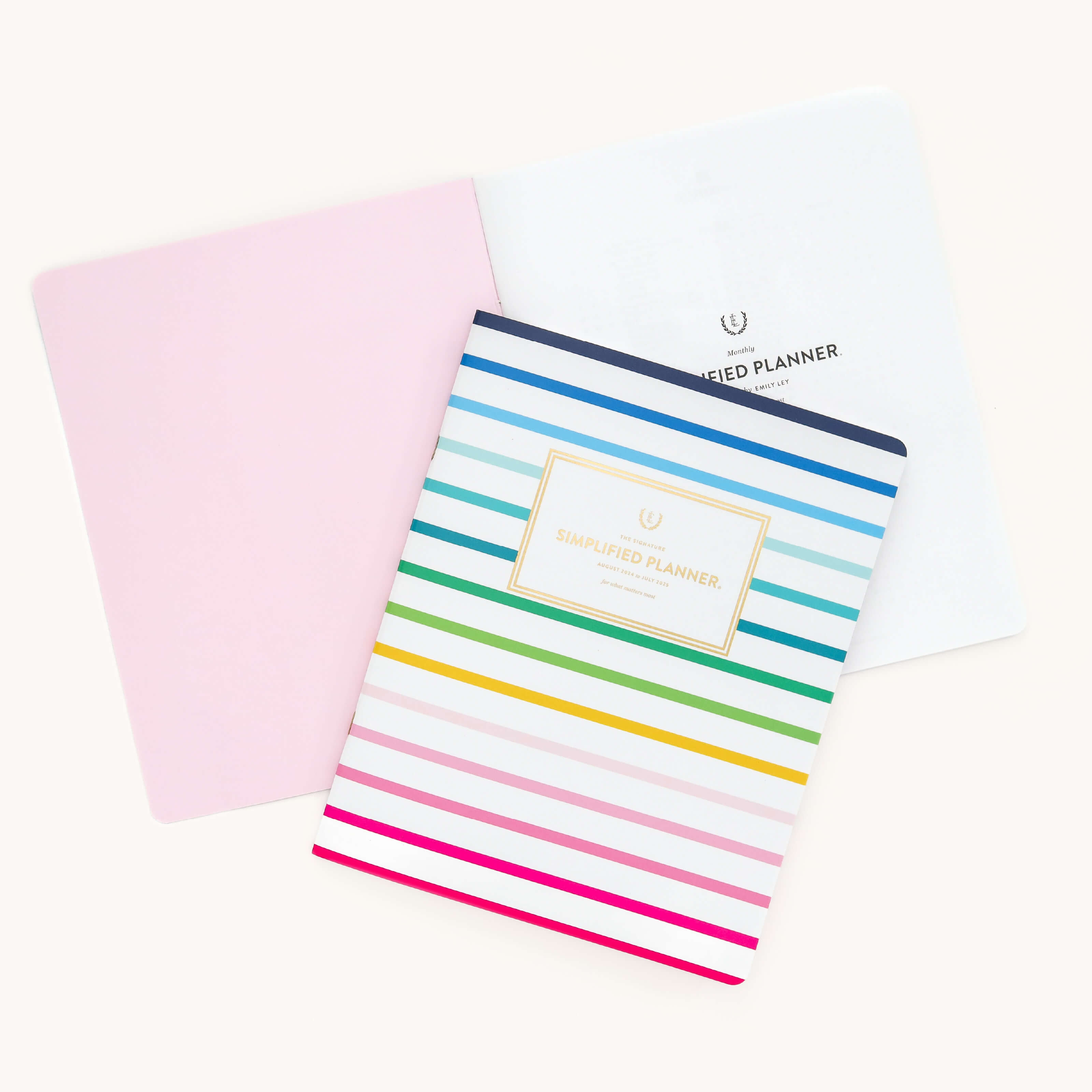 2025 Calendar Year Monthly Planner by Emily Ley featuring the Happy Stripe cover with a blush inside cover.