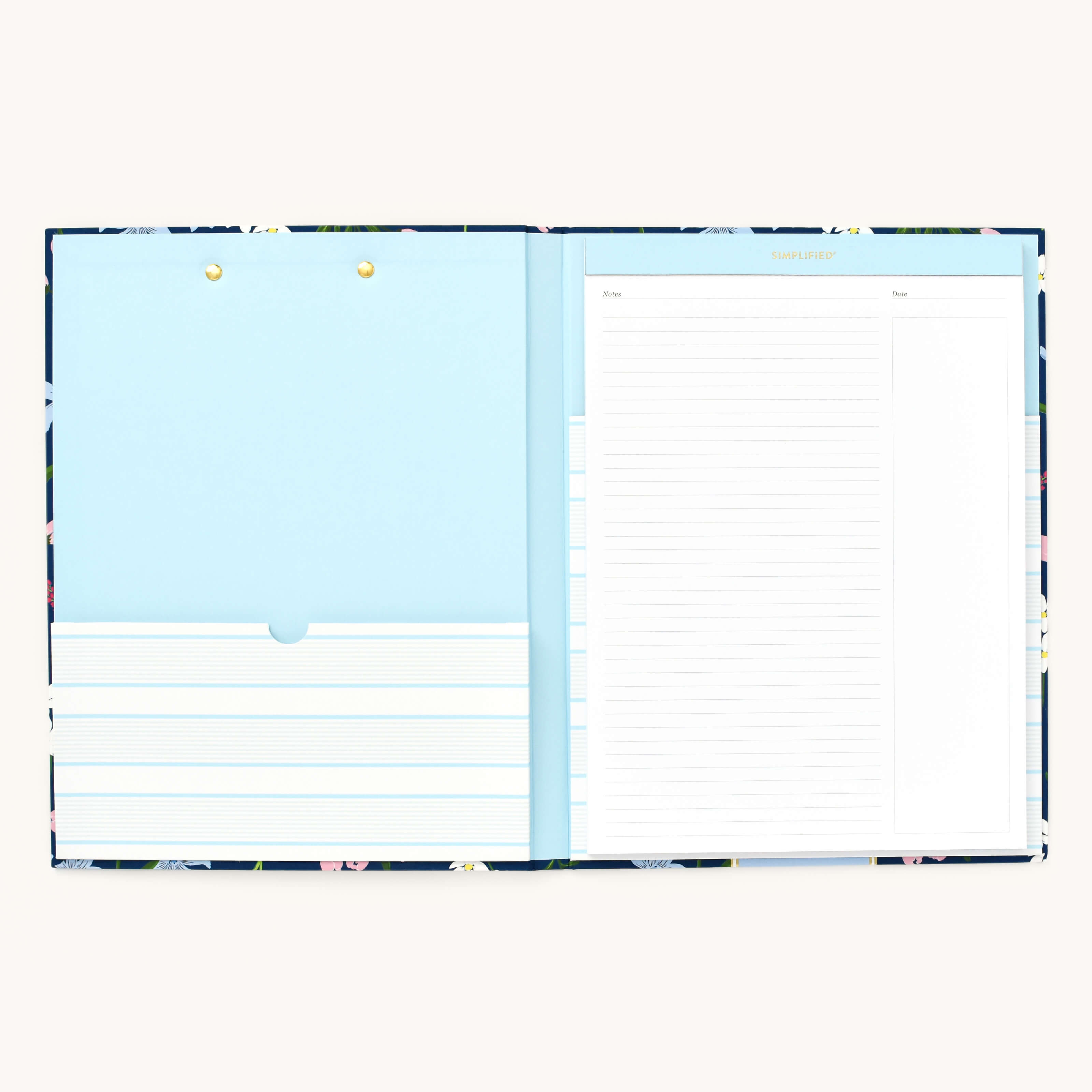 The Clipfolio - Navy Wildflowers by Simplified includes a floral notebook with lined pages on the right and a blue folder pocket with brass fasteners on the left, perfect for organizing documents.