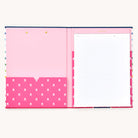 The Clipfolio - Happy Stripe by Simplified features an open notebook with a pink interior. The left pocket has white floral patterns and two top gold fasteners for organizing essentials, while lined paper on the right shows a Simplified header. Its light grey background complements the cheerful striped cover.