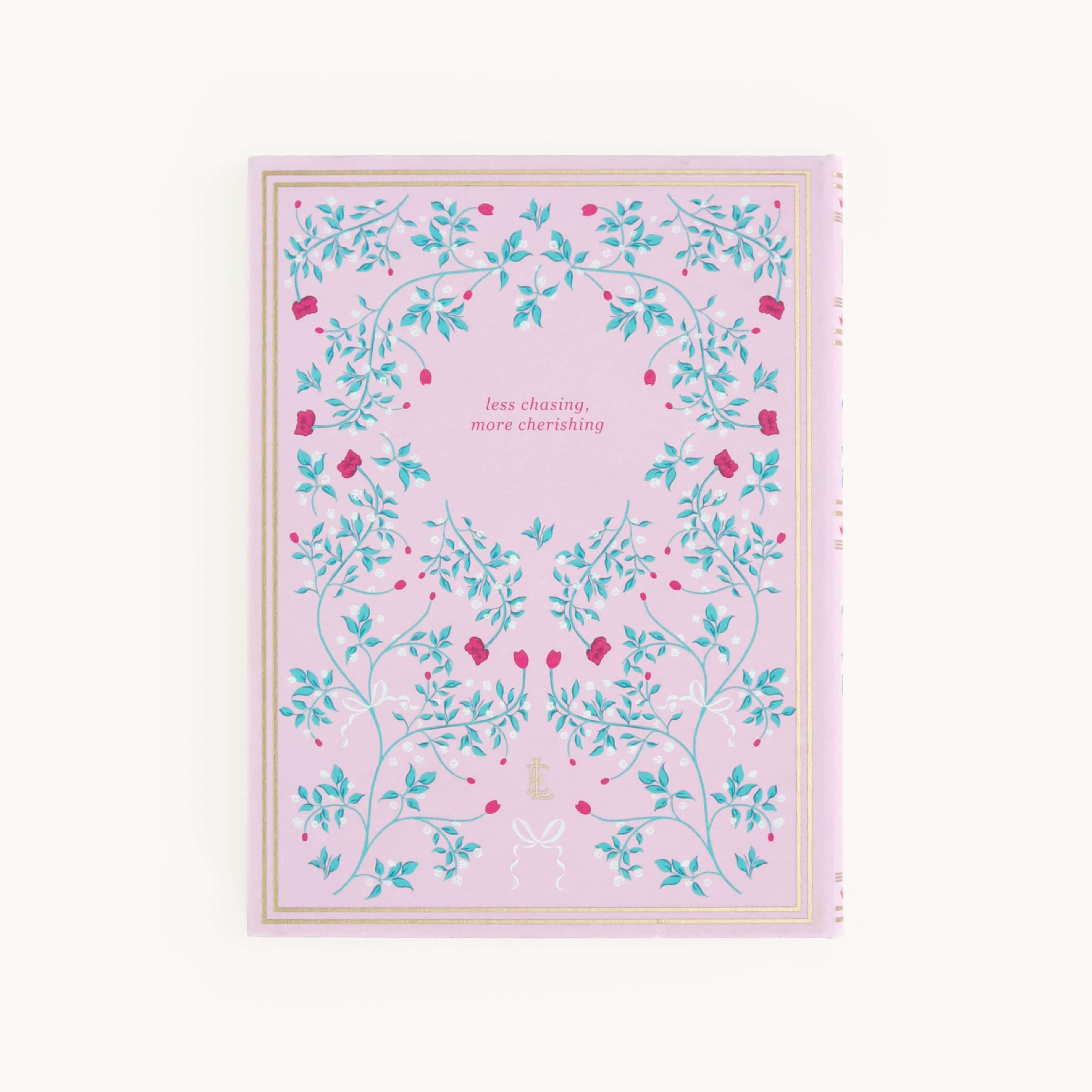 The Linen Journal - Blush by Simplified, adorned with green leaves and red flowers, has a gold border and the inspiring phrase less chasing, more cherishing, making it ideal for sparking creativity in your daily writings.