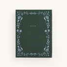 The Linen Journal - Grace by Simplified features a green cover elegantly embossed with GRACE in gold at the center. A hand-painted blue floral border frames the linen cover, set against a simple off-white background, making it a true masterpiece.