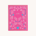 The Linen Journal - Raspberry by Simplified showcases a pink cover with white floral and vine patterns, accented by blue elements and the phrase less stuff, more treasures. A gold border elegantly frames this perfect companion for creativity or reflection.