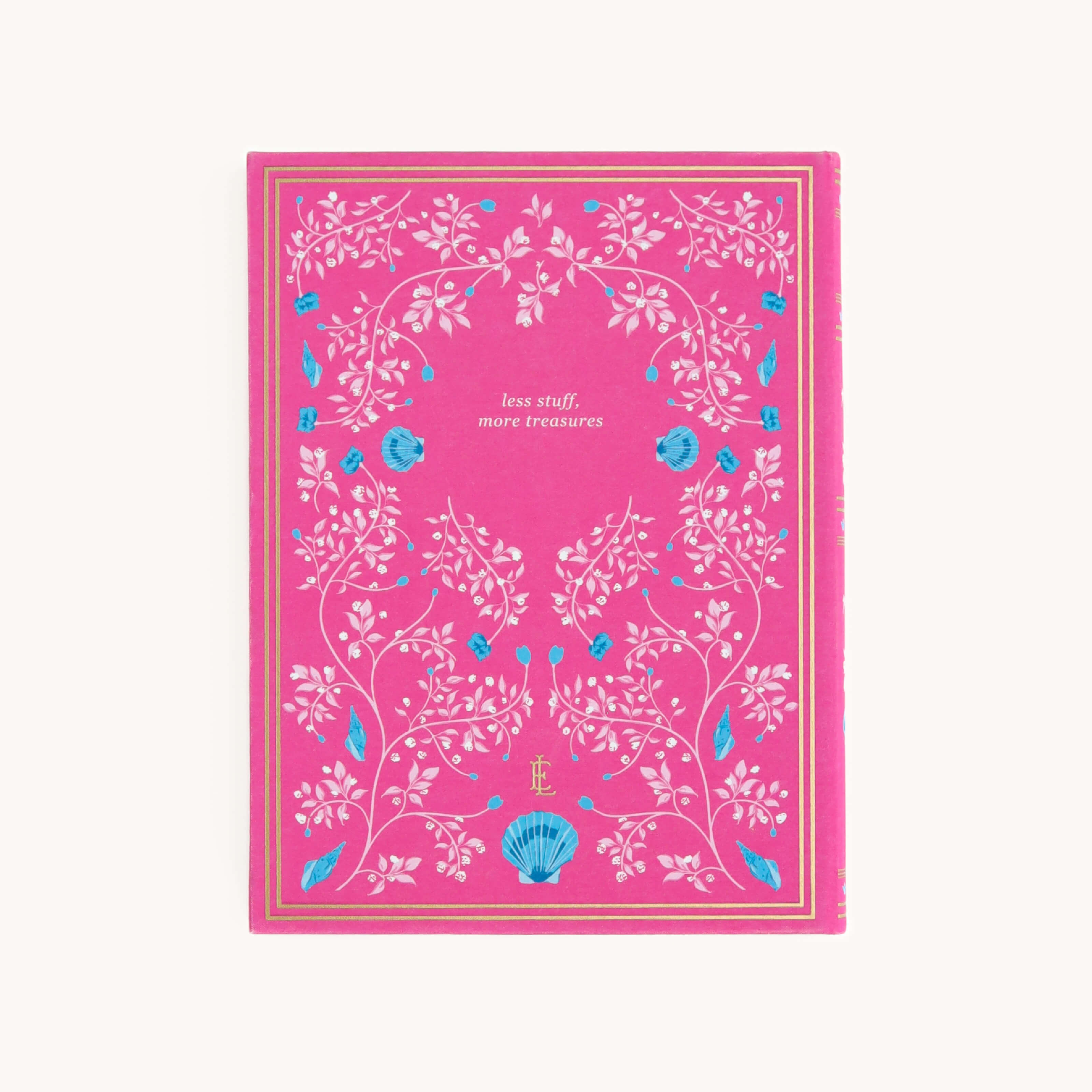 The Linen Journal - Raspberry by Simplified showcases a pink cover with white floral and vine patterns, accented by blue elements and the phrase less stuff, more treasures. A gold border elegantly frames this perfect companion for creativity or reflection.