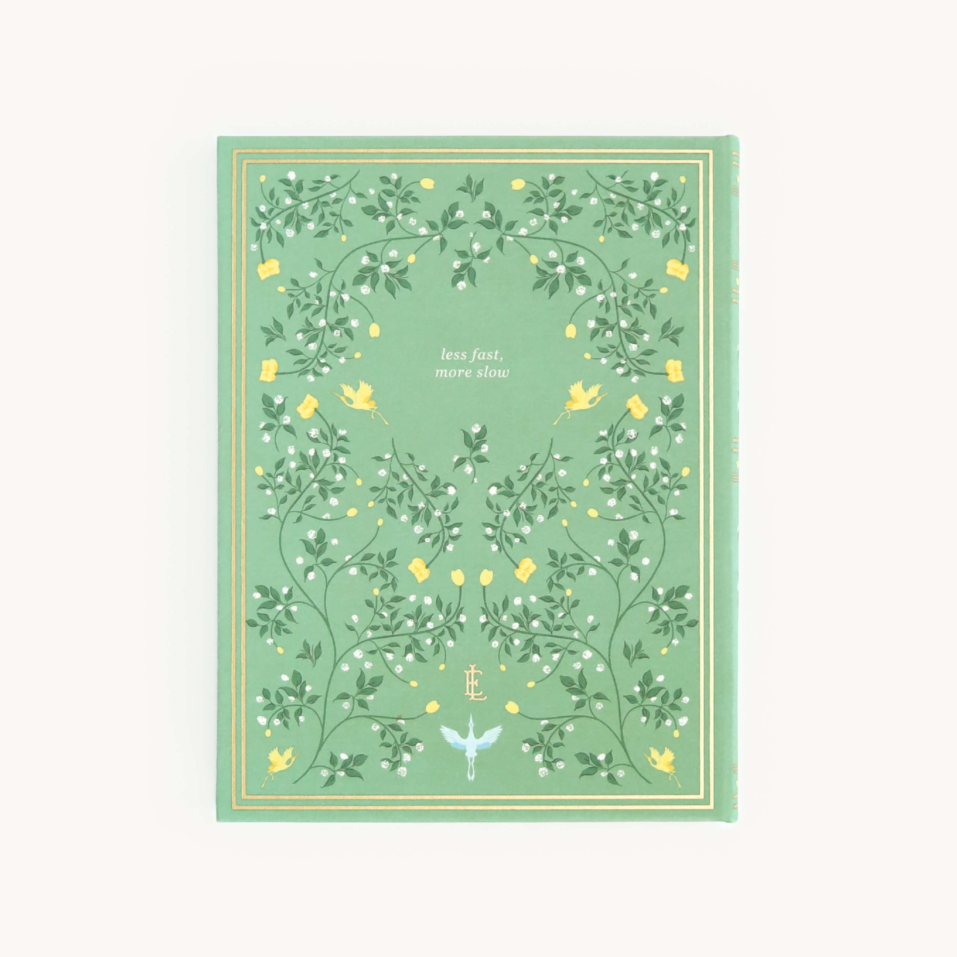 The Linen Journal - Sage by Simplified features an ornate cover with intertwining vines and yellow flowers, titled less fast, more slow. A delicate dragonfly graces the bottom center, inviting reflection and creativity.