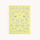 The Linen Journal - Yellow by Simplified features a yellow cover with blue floral patterns and bees, centered with the inspiring text less busy, more balance. Perfect for users seeking creativity and harmony through journaling.