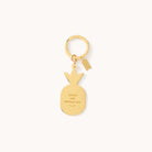 The Pineapple Key Chain by Simplified is a gold enamel keychain shaped like a pineapple with Grace Not Perfection inscribed, adding elegance and sparkle to your style. It hangs from a round keyring and includes a small rectangular tag on a plain white background.