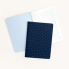 Mini notebooks from Simplified are showcased on a light background. One notebook is open, showing lined pages, while the closed Mini Notebook - Dainty Dot features a dark blue thick paper cover with small, light dot patterns.