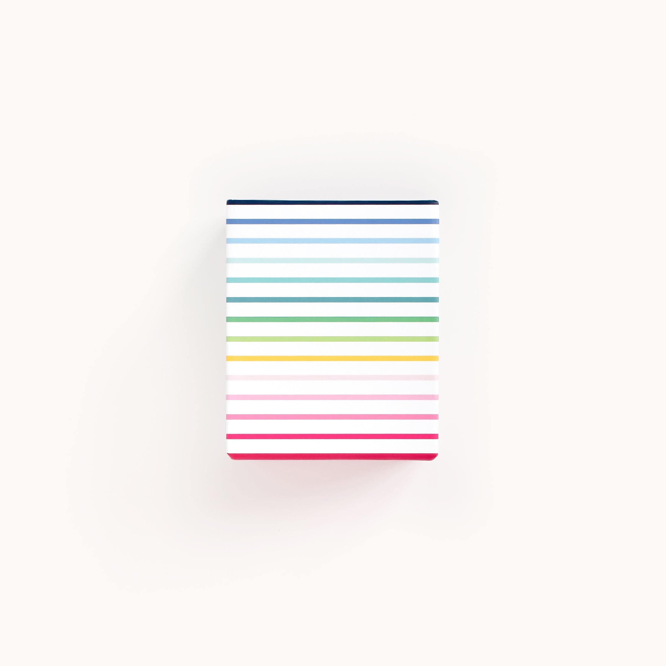 The Patterned Pen Cup - Happy Stripe by Simplified is square-shaped with a light background and horizontal, equally spaced colorful stripes in shades of blue, green, yellow, pink, and red.