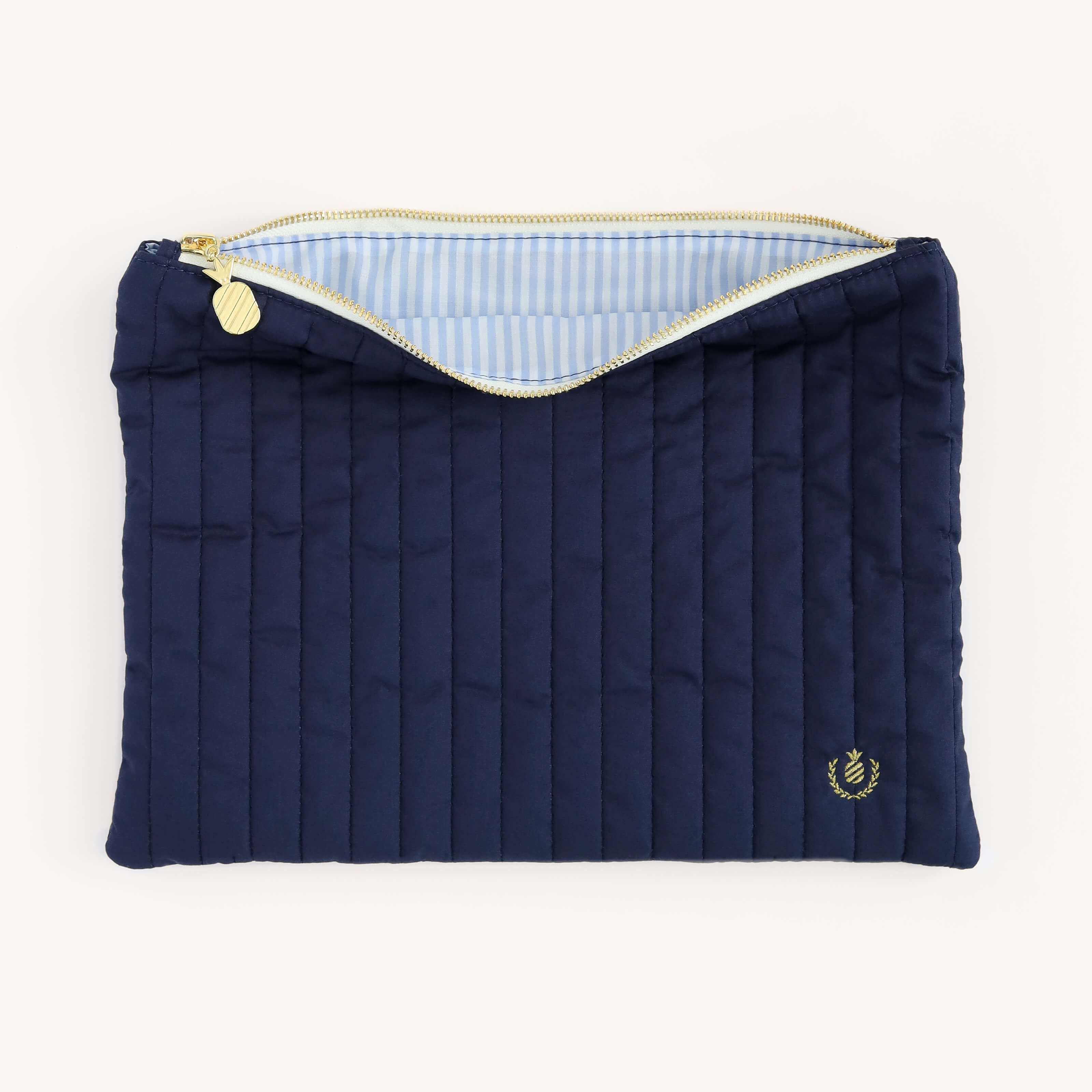 Interior view of the Navy Quilted Pouch, showcasing the coastal blue stripe interior. 