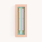 Simplified by Emily Ley | Twist Pen Set featuring two metal pens in Cabana Pinstripe and Blush Block designs, shown in a ivory two-piece box with a clear view window.