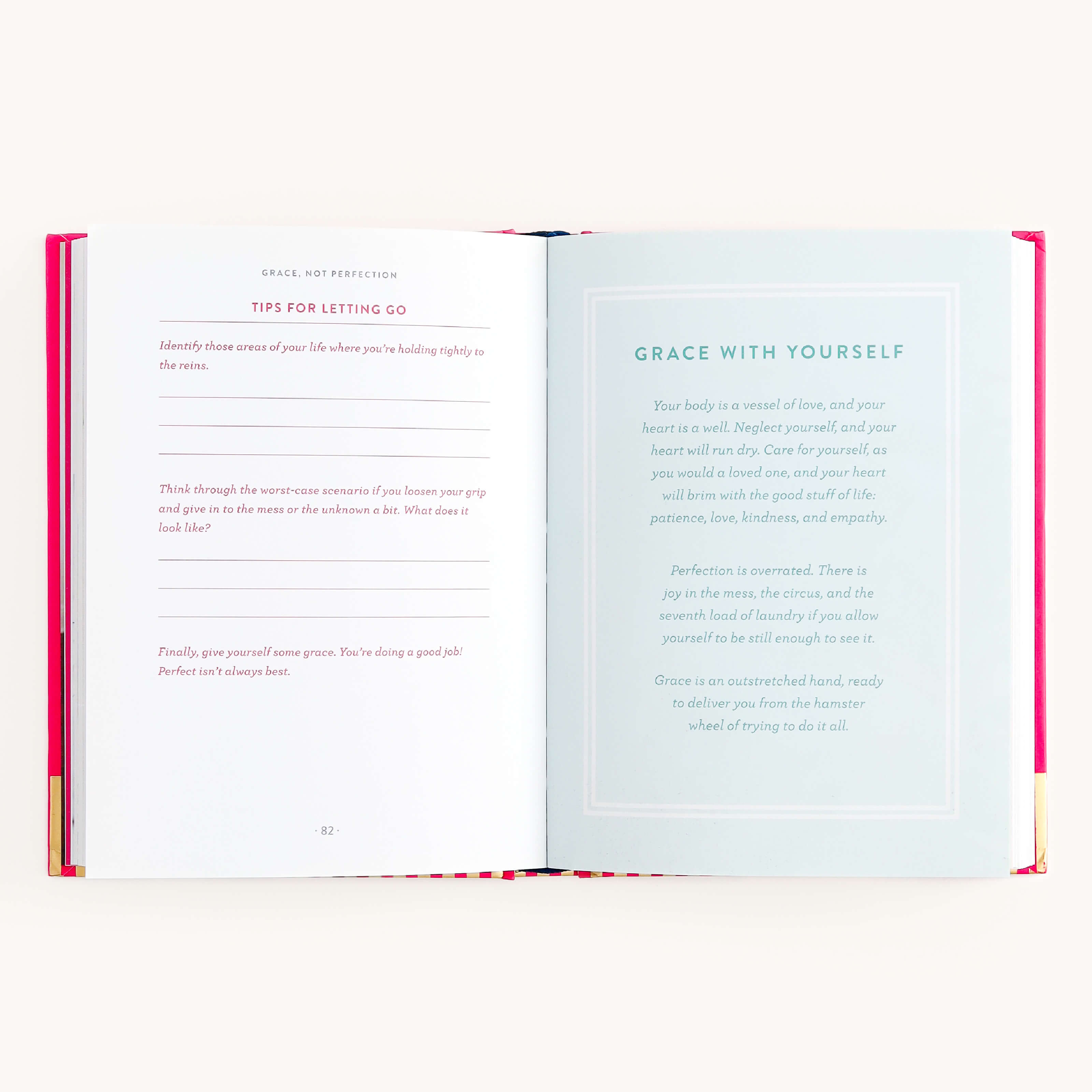 Place the Grace Not Perfection book by Simplified on a flat surface. The left page, Tips for Letting Go, has fill-in-the-blanks and life-guiding questions. The right, titled Grace With Yourself, includes text on self-love and embracing imperfection in cursive and regular fonts on white.