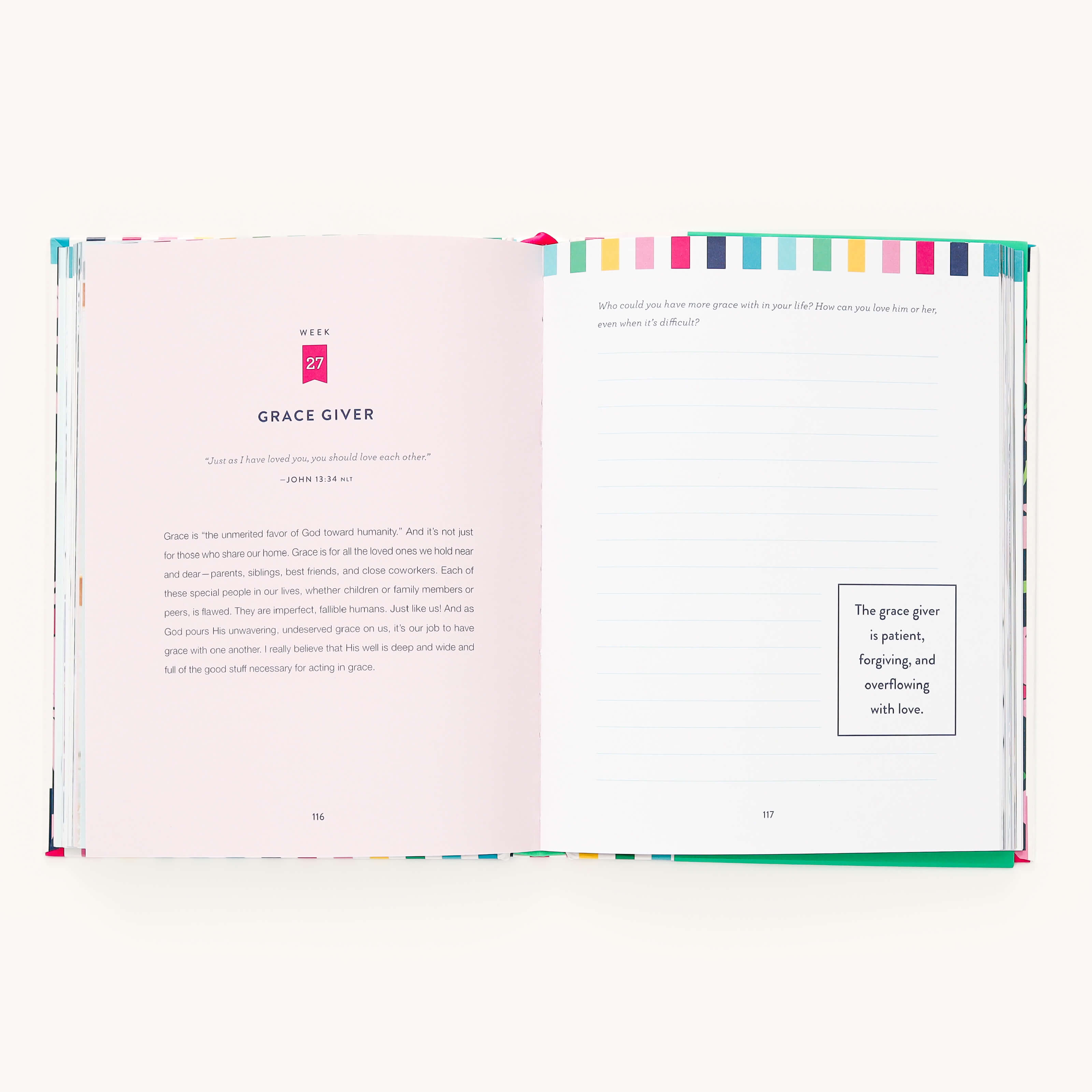 The open book, A Standard of Grace by Emily Ley under the Simplified brand, features a colorful striped border. The left page reads Grace Giver, while the right provides lined space for self-reflection prompts and a framed quote about grace. The pages are light pink with a clean layout.