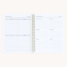 The open spiral-bound Simplified Workbook - Hosting organizes seasonal decor ideas for spring, summer, fall, and winter on the left page. The right page features an Inventory with sections for party supplies, storage, kitchen items, and more to enhance your gatherings.