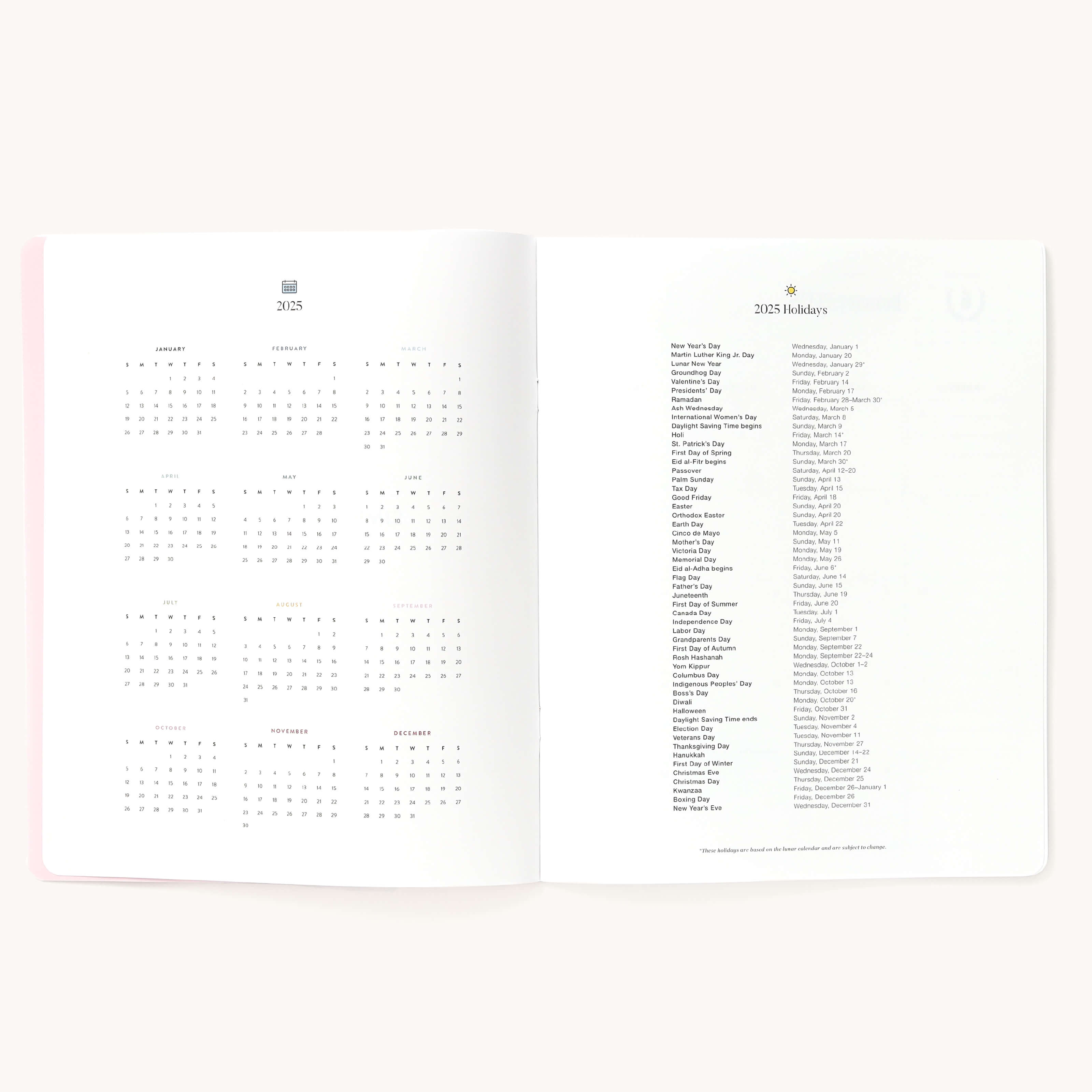 2025 Calendar Year Planner by Emily Ley in Happy Stripe cover open to the yearly calendar overview and holidays list. Features a two-page spread with a full 12-month calendar view on the left and important U.S. holidays on the right. 