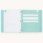 The Baby Book - Mint by Simplified is an open ring binder scrapbook with turquoise pages. The left page, titled mommy & daddys story, has polka dots and writing spaces; the right page includes sections for family details, a photo square, and customizable design elements—ideal for a personalized baby book.