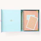 2024-2025 Academic Year Daily Simplified Planner by Emily Ley in the Cabana Pinstripe cover design, placed inside a light blue and green keepsake box with gold foil detailing. Includes a matching art print for added inspiration. Perfect for organization, time management, and productivity. 