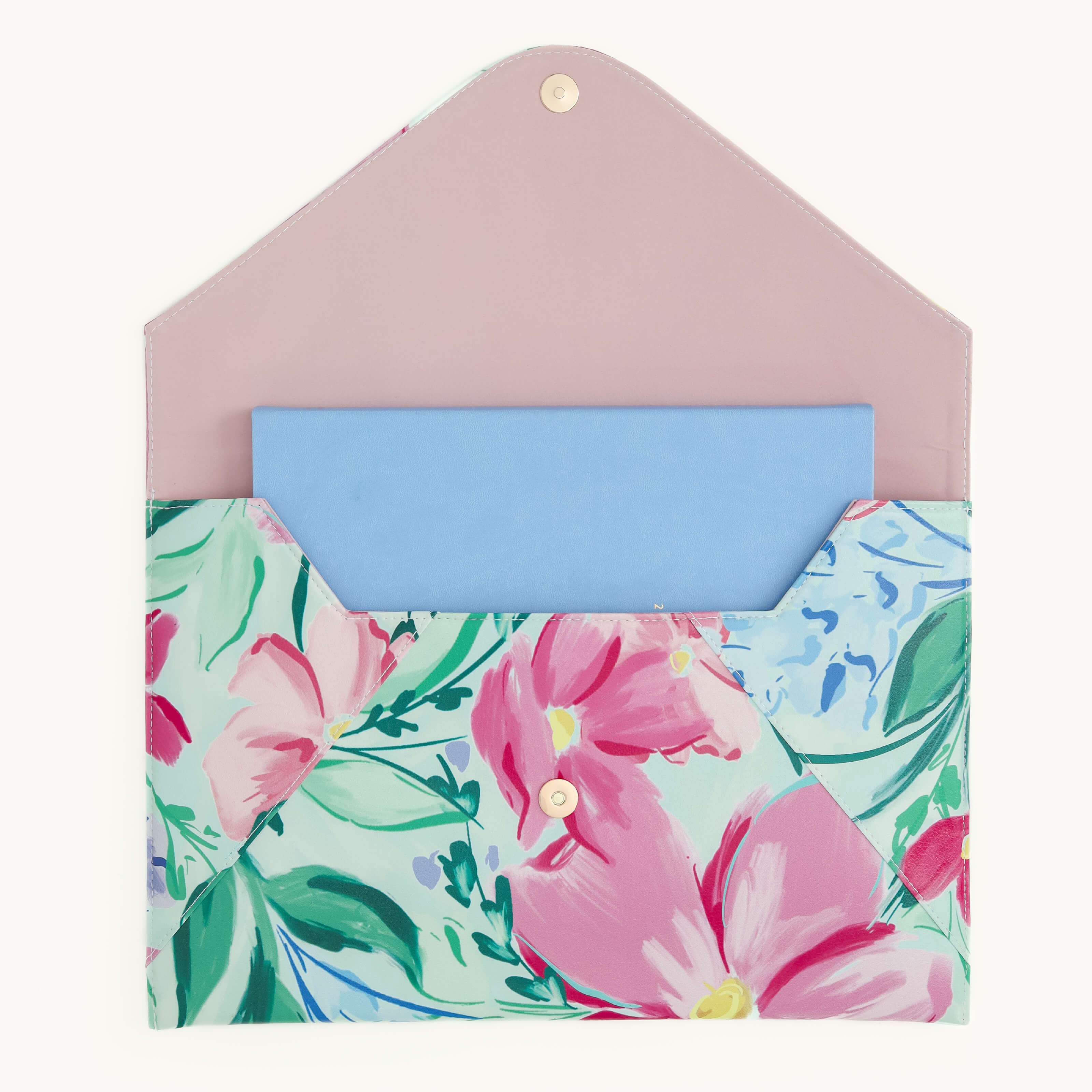 The Simplified Leatherette Tech Case - Blush Magnolia features a floral pattern with a pastel pink flap, a snap closure, and pink and green designs. Inside, you can see a light blue rectangular card.