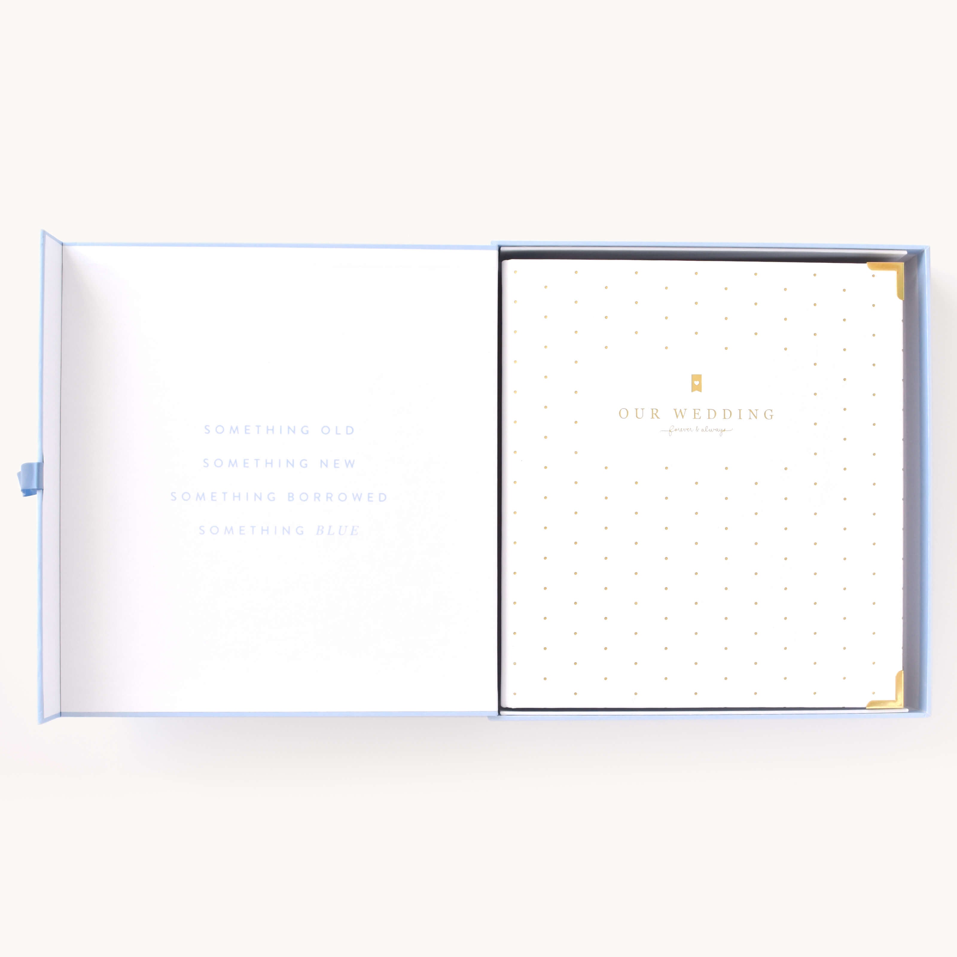 Simplified Wedding Planner by Emily Ley displayed inside its Carolina blue keepsake box. Features a gold foil polka dot cover with ‘Our Wedding’ embossed in gold, protective gold corners, and a timeless 'Something Old, Something New, Something Borrowed, Something Blue' inscription inside the box.