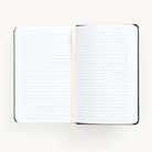 2025 Daily Dapperdesk Planner in the Black Tie leatherette cover open to the notes pages. Features a two-page spread with blank lined notes pages and ivory grosgrain ribbon page marker. 