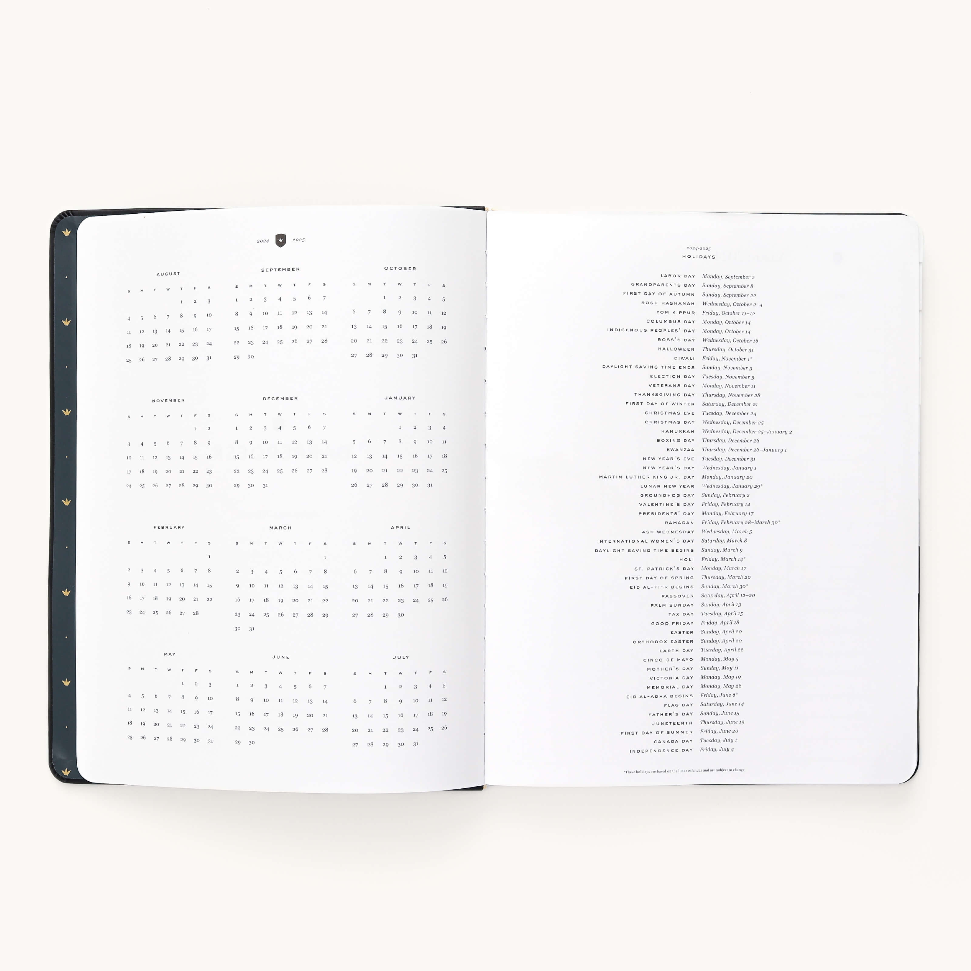 The 2024-2025 Weekly Dapperdesk Planner - Black Tie by Simplified features an open layout with a year calendar (Aug to Oct) and world holidays. Its leatherette cover with gold dots adds elegance, while high-quality paper enhances sophistication against an off-white background.